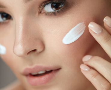 Beauty Cosmetics. Closeup Of Attractive Sexy Smiling Girl Face With Stripe Of Cosmetic Product, Skin Care Cream On. Beautiful Healthy Young Woman With Soft Skin And Natural Makeup. High Resolution